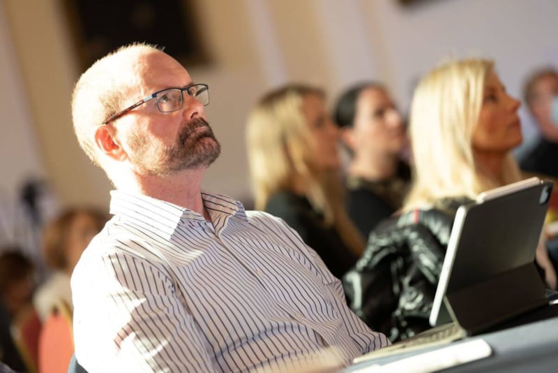 Doctor sitting in row in audience
